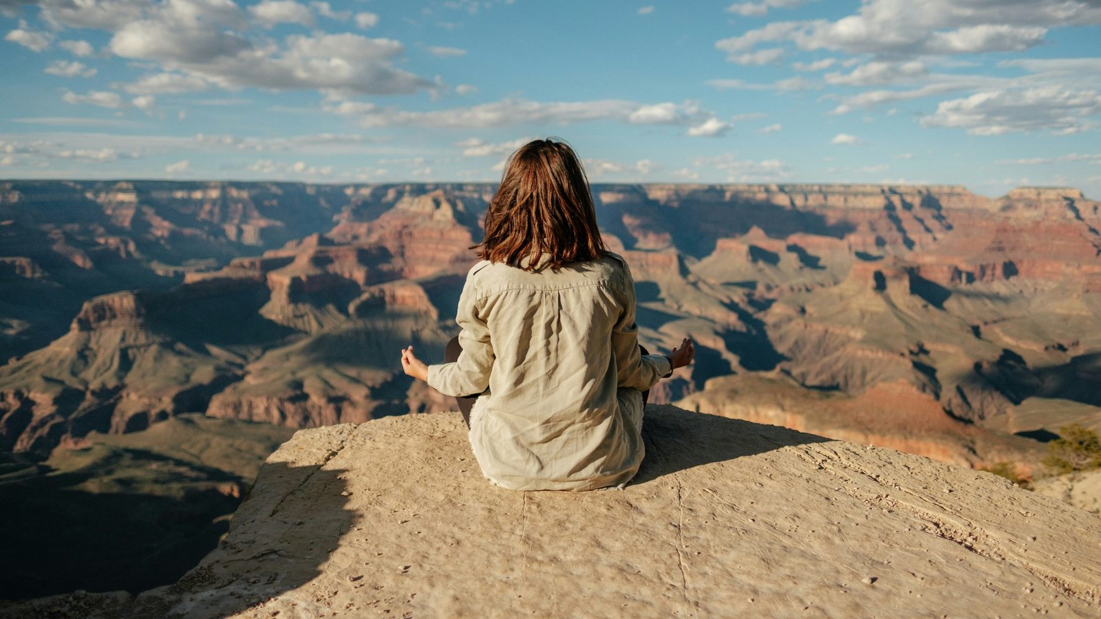 Woman Praying Meditating with beautiful mountain landscape by Metteo Di-Iorio